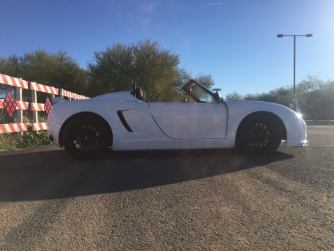 2015 Subaru Impreza - A white convertible sports car is parked outdoors under a clear blue sky.