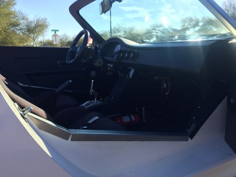 2015 Subaru Impreza - The interior of a custom sports car is visible, racing seats and a fire extinguisher mounted on the passenger side.