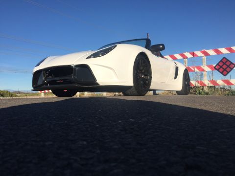 2015 Subaru Impreza - White convertible sports car with black wheels parked near a railroad crossing sign.
