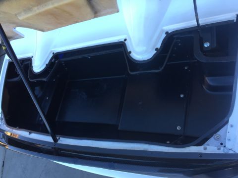 2015 Subaru Impreza - The interior of a vehicle's trunk is shown, black lining and white fiberglass construction.