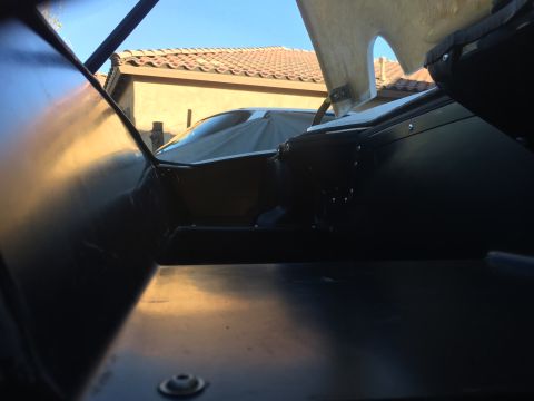 2015 Subaru Impreza - Interior view of a car, with another vehicle covered by a tarp visible outside.