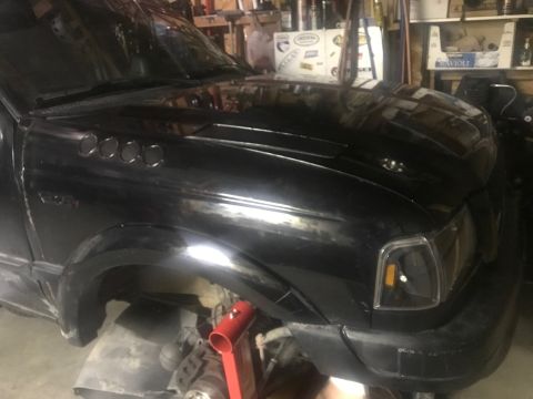 2000 Ford Explorer - A black SUV is shown from the front quarter angle, supported by a jack.