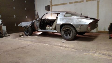 1979 Chevrolet Camaro - This 1979 Chevrolet Camaro is in a garage, appearing to be in the process of restoration with its bare metal body.