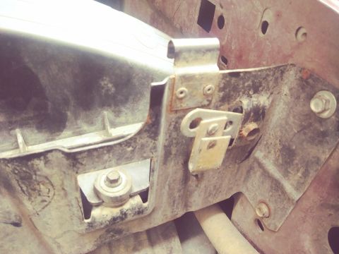 1996 Ford Bronco - Undercarriage bracket with visible bolts and mounting hardware.