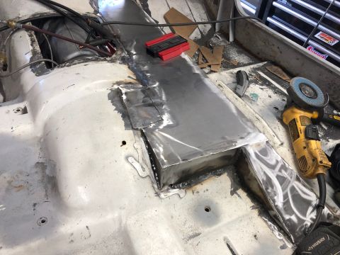 1992 Jeep Wrangler - The interior floor of a vehicle is undergoing repair with new metal panels welded into place.