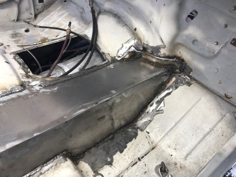 1992 Jeep Wrangler - Close-up view of a vehicle's interior floor pan showing recent welding work and exposed wiring.