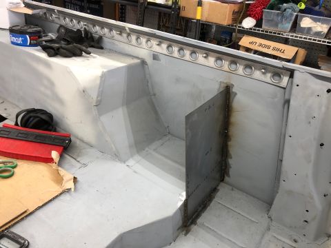 1992 Jeep Wrangler - The interior of a vehicle is being worked on, with new metal panels welded in place.