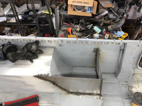 1992 Jeep Wrangler - The interior of a vehicle is shown, with evidence of body work and tools scattered around the garage.