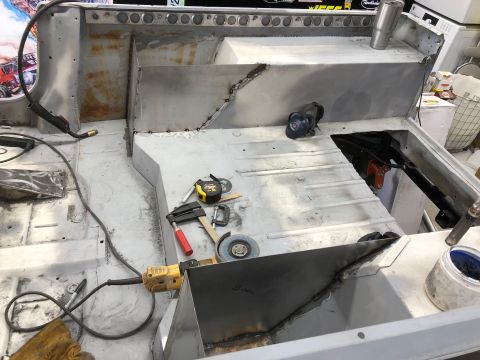 1992 Jeep Wrangler - Metal fabrication and welding are underway inside a vehicle's interior, with various tools scattered around.