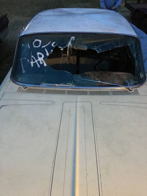 1961 Ford Starliner - A white car with a heavily damaged windshield, marked with "10 PARTS" in white lettering.