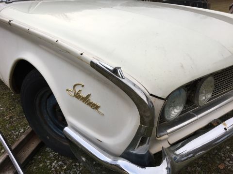 1960 Ford Starliner - Close-up of a white 1960 Ford Starliner showing its distinctive fender script and front-end chrome details.