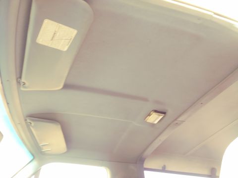 1996 Ford Bronco - Interior view of a vehicle's headliner, showing sun visors and a light fixture.