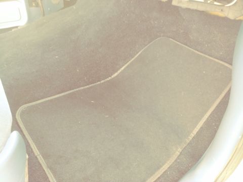 1996 Ford Bronco - A close-up view of a car's interior floor mat, showing its texture and trim.
