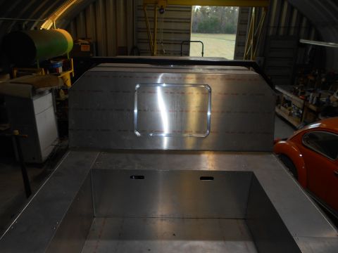 1992 Ford Bronco - The interior of a custom aluminum truck bed is shown, with a portion of an orange car visible in the background.