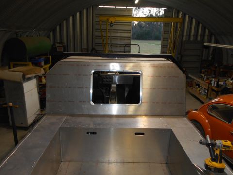 1992 Ford Bronco - Custom aluminum interior build in progress, with a vintage VW Beetle nearby.