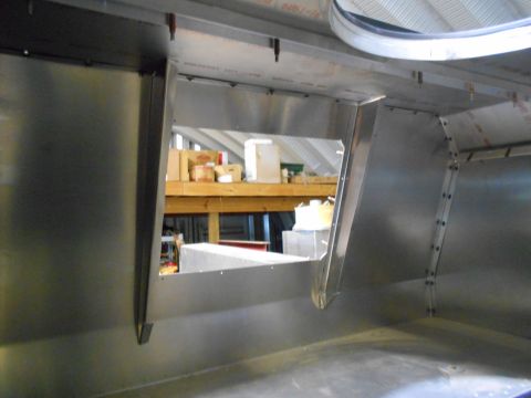 1992 Ford Bronco - The interior of a metal structure shows unfinished walls and a view of shelves with boxes.