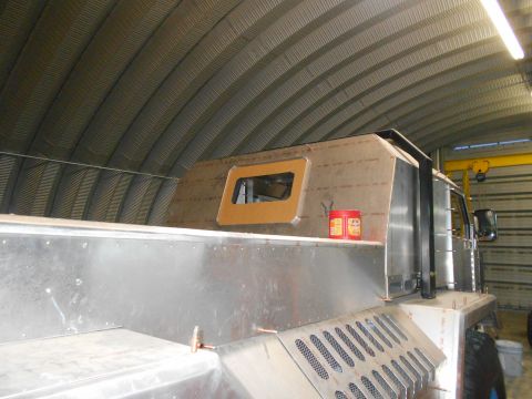 1992 Ford Bronco - Custom truck build in progress inside a garage with a corrugated metal ceiling.