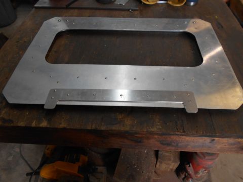 1992 Ford Bronco - An aluminum frame, likely a vehicle part, rests on a workbench. The registry claims it is from a 1992 Ford Bronco.