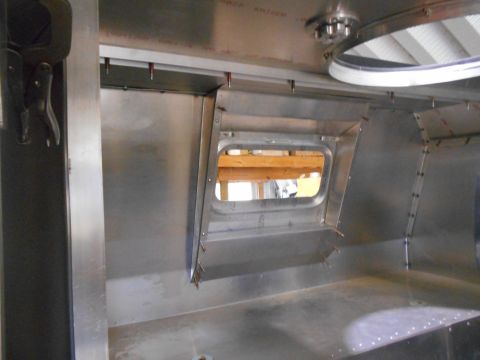 1992 Ford Bronco - Metal interior construction with a small window, possibly part of a custom build or repair project.
