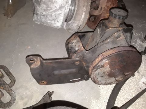 1994 Ford Bronco - This is a power steering pump assembly, likely from an older vehicle. It shows signs of wear and rust.