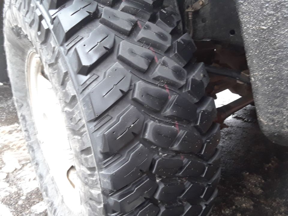 Close-up of a large off-road tire with aggressive tread