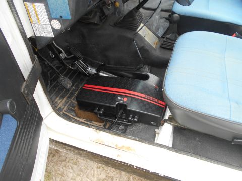 1992 Ford Bronco - Vehicle interior with a portable brake system installed on the floor near the driver's seat.