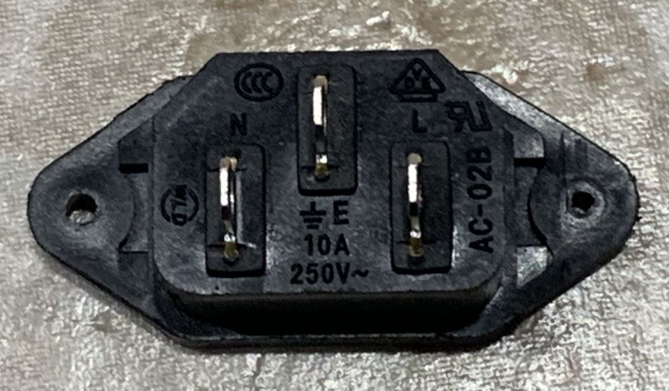 Black AC power inlet socket with N, L, E, 10A, 250V~, AC-02B markings and logos.