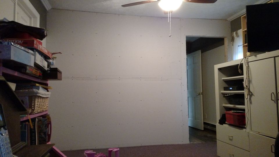 Interior scene with stacked boxes, shelves, and a ceiling fan