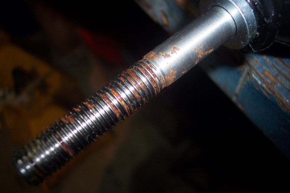Close-up of a rusty threaded metal rod.
