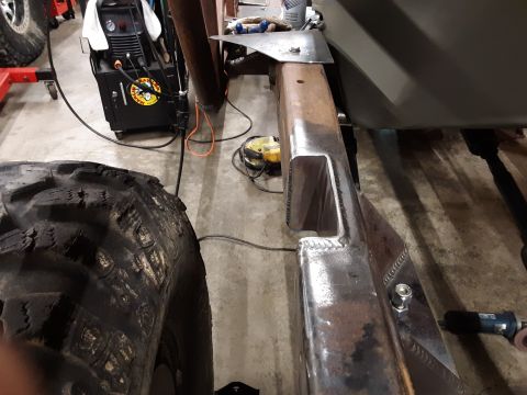 1985 Toyota Hilux - A close-up view of a custom-fabricated metal frame component, possibly for a vehicle suspension or chassis, showing welded seams and a bolt…