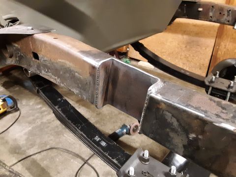 1985 Toyota Hilux - A close-up view of a welded steel frame section of a vehicle, likely a truck, with leaf springs visible below. The frame appears to be unde…
