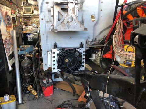 1992 Jeep Wrangler - A close-up view of the front of a vehicle build, showing a cooling fan mounted in front of a radiator, with various engine components and w…