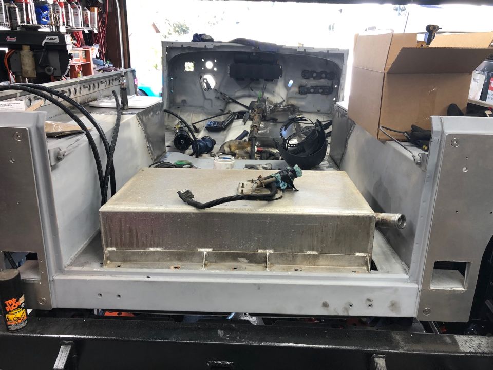 Jeep Wrangler interior with fuel tank installed, showing wiring and restoration parts.