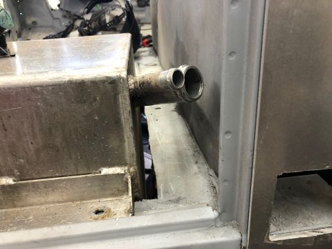 1992 Jeep Wrangler - A close-up view shows a dual-pipe exhaust system attached to a metal tank, likely part of a vehicle's fuel or exhaust system. The pipes are…