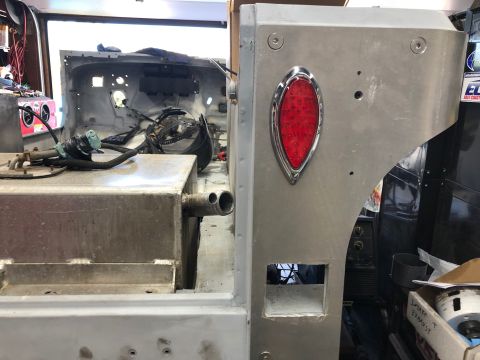 1992 Jeep Wrangler - The rear passenger side of a vehicle under restoration is shown, featuring a large aluminum fuel tank and a red oval LED taillight mounted…
