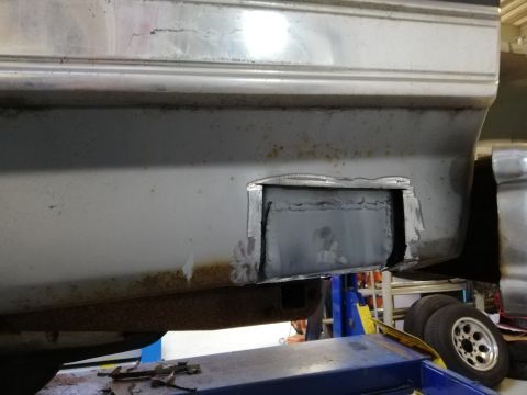 1996 Ford Bronco - Undercarriage component detail, focus on metal structure and an access panel.