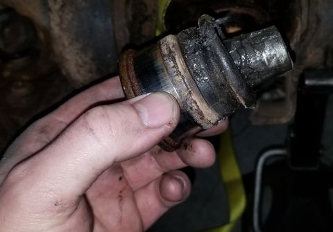 2001 Ford Excursion - This ball joint appears to be heavily worn and damaged, likely needing replacement.