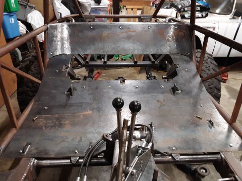 1985 Toyota Hilux - Interior view of a custom-built off-road buggy, dual shifters and a raw metal construction.