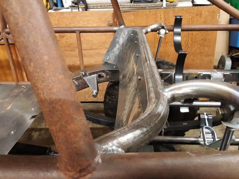1985 Toyota Hilux - Close-up view of a vehicle's frame and suspension system, showing metal tubing and leaf springs.