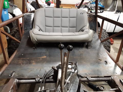 1985 Toyota Hilux - Interior view of a custom buggy build, showing a seat and dual shifters.