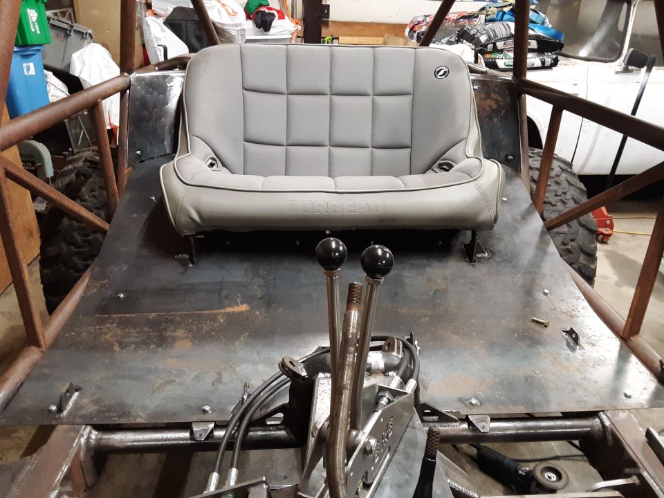 Gray bucket seat in a custom buggy frame with dual shifters visible