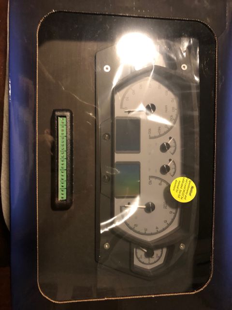 1992 Jeep Wrangler - A gauge cluster with multiple dials and digital displays is shown, packaged for sale.