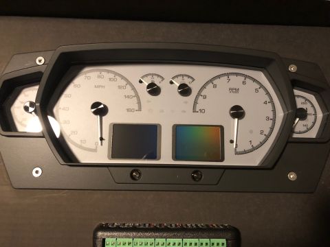 1992 Jeep Wrangler - Digital gauge cluster with MPH and RPM readouts, and two small display screens.