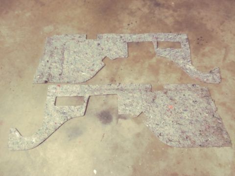 1996 Ford Bronco - Two automotive insulation panels are shown on a concrete surface.