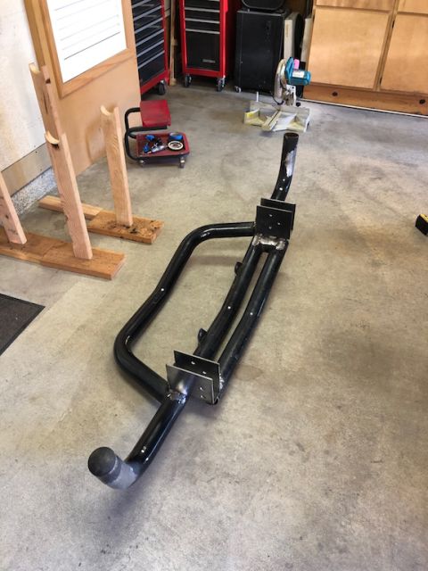 1981 Ford Bronco - Aftermarket rear bumper with integrated tow hitch, likely for an off-road vehicle, is shown on a garage floor.
