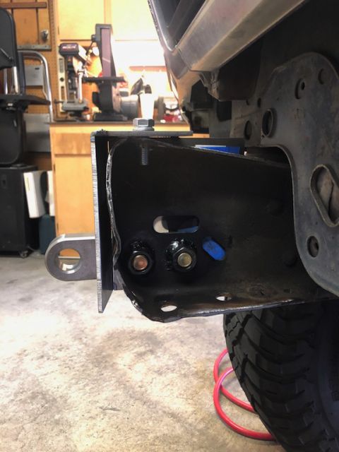 1981 Ford Bronco - Close-up of a vehicle's frame and tow hitch assembly, with a tire visible.