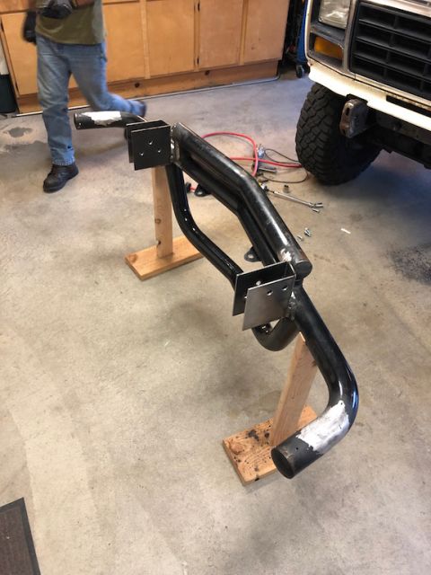 1981 Ford Bronco - Custom front bumper assembly being worked on in a garage, with a vehicle in the background.