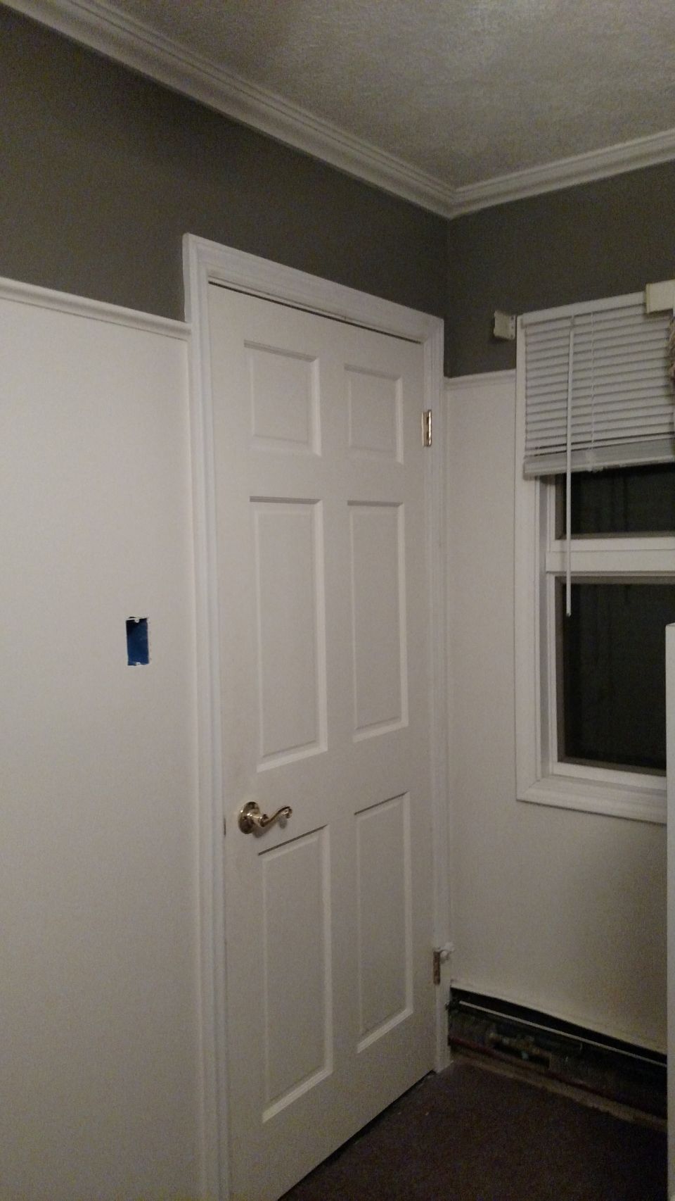 Interior door with brass handle and window with blinds