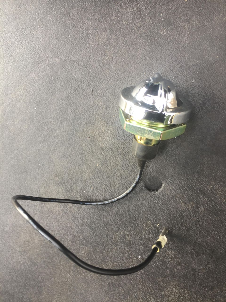 Chrome dome light switch with black wire and connector, mounted on a hexagonal nut