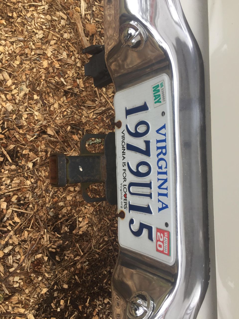 Rear bumper chrome trim, trailer hitch, and Virginia license plate reading 1979 U15